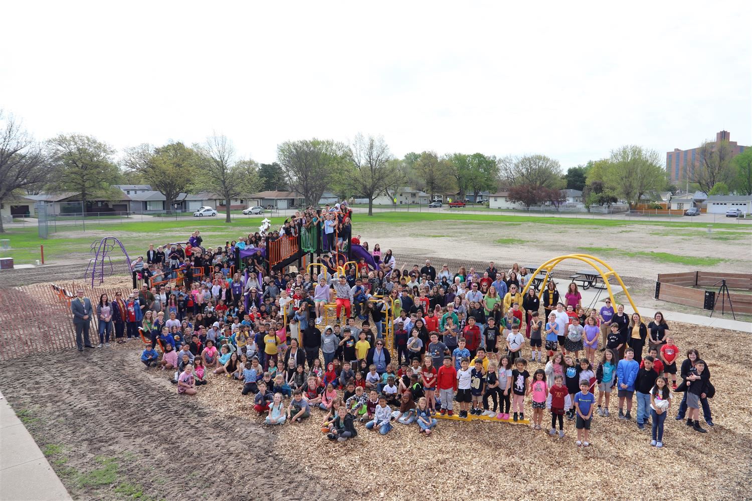 Newell staff and students smiling on the new playground.